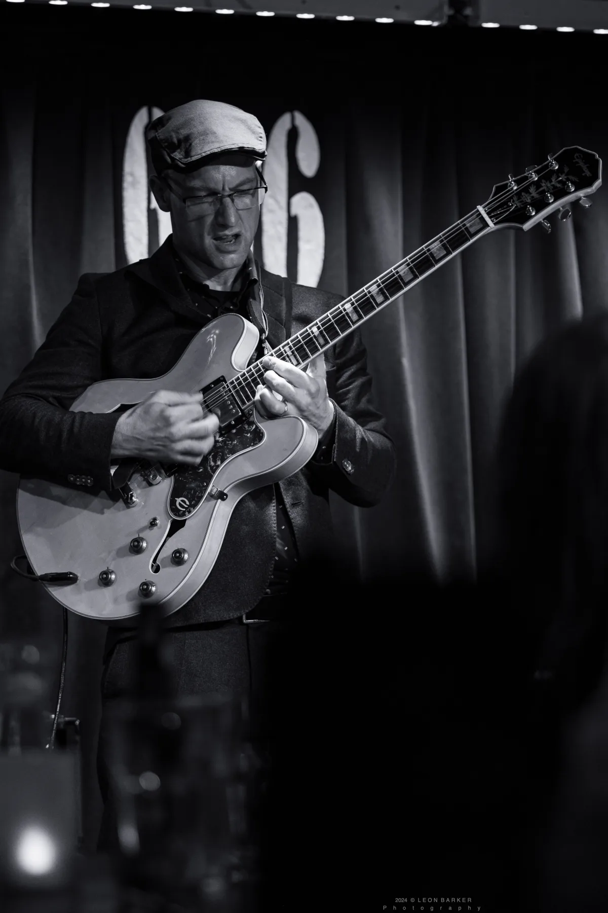 Pete Roth with an electric guitar for Pete Roth Trio.