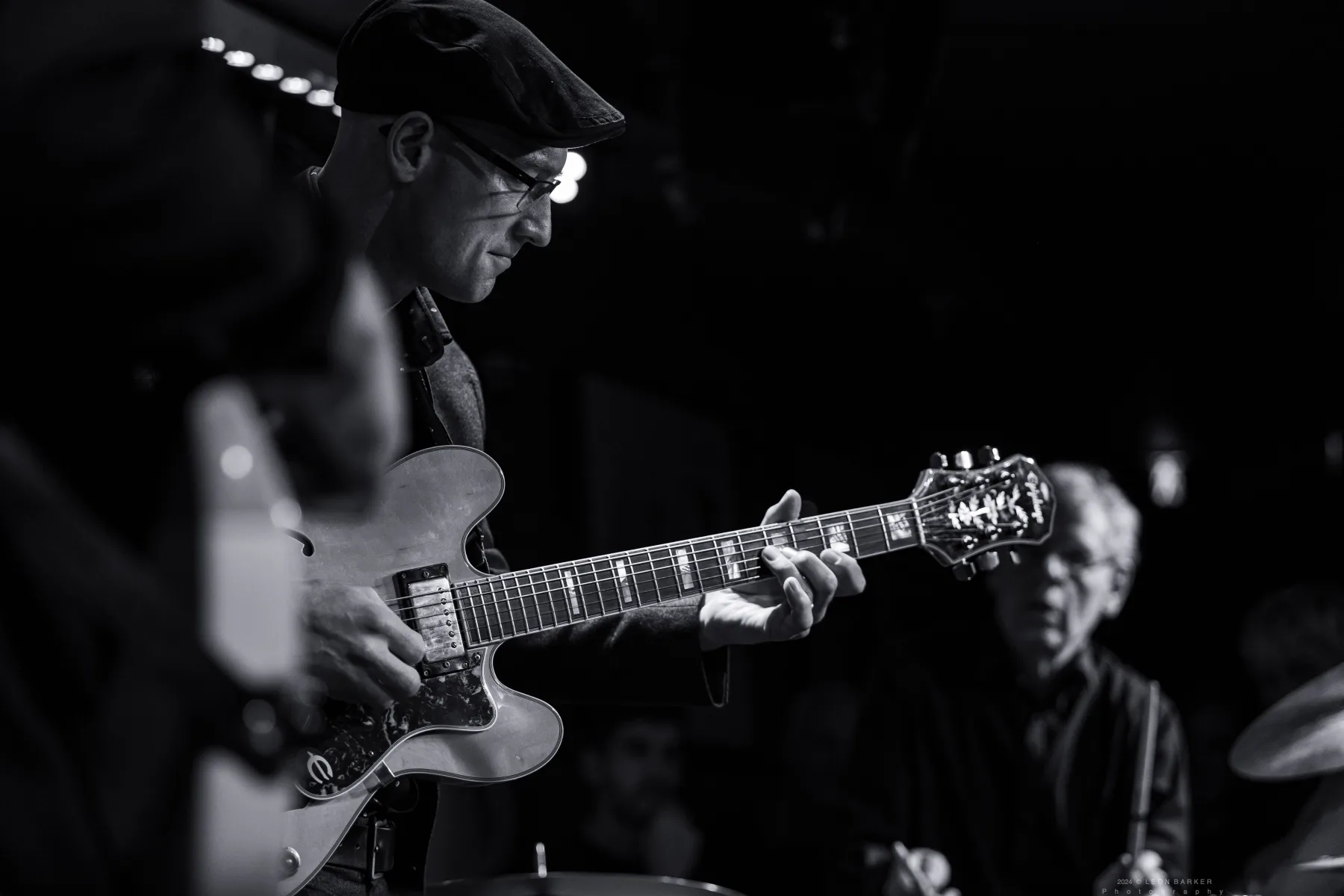 Pete Roth Trio musicians listening closely during a live performance.