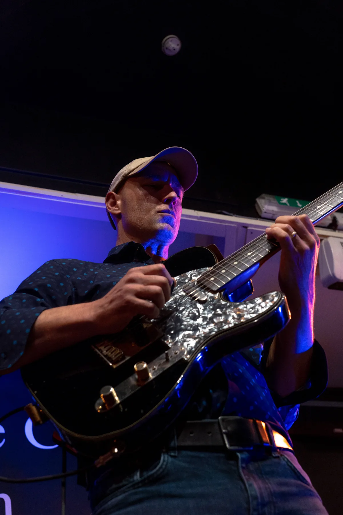 Pete Roth Trio close-up performance image with guitar and drums.